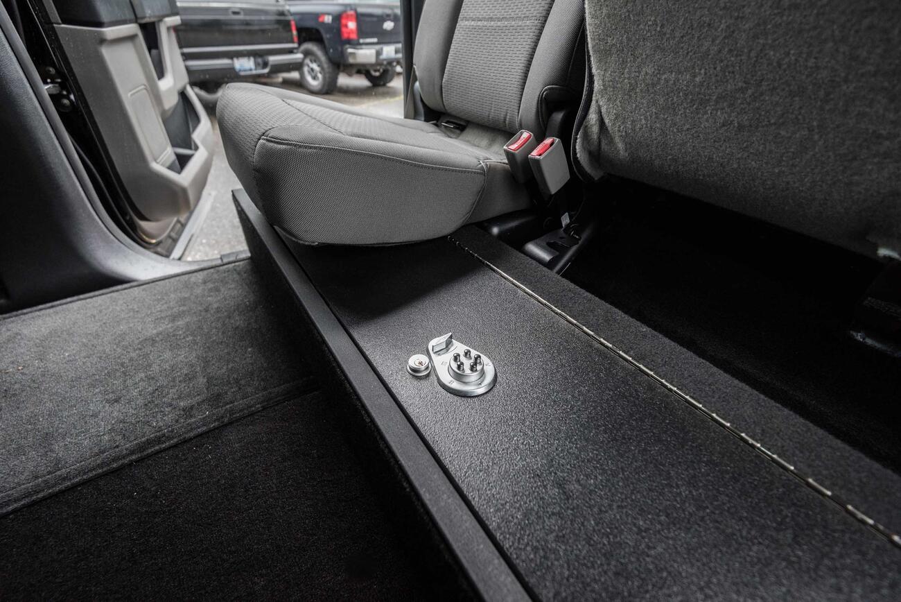 A SeatVault in the back of a Ford F150 with one seat folded down.
