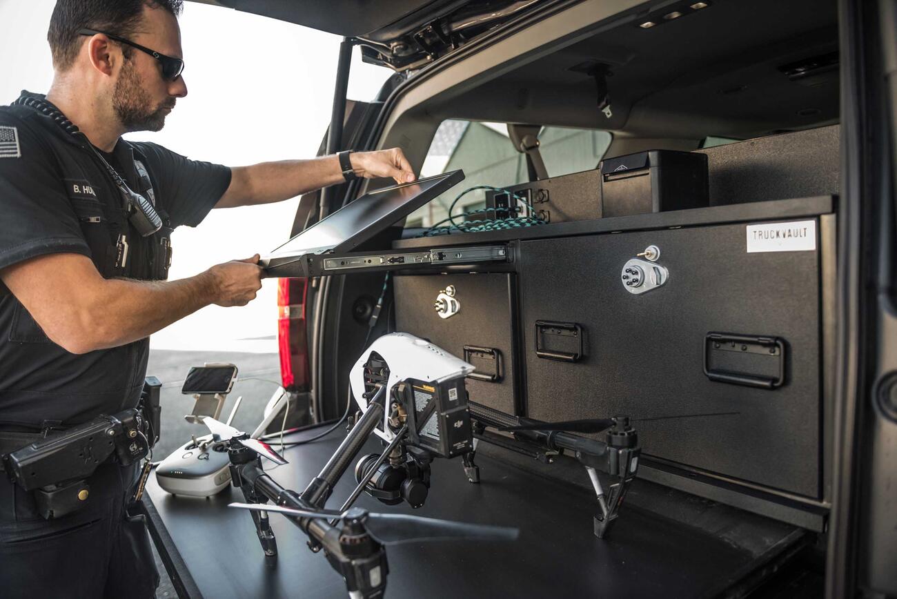 A police officer opening his drone viewing screen on his TruckVault.
