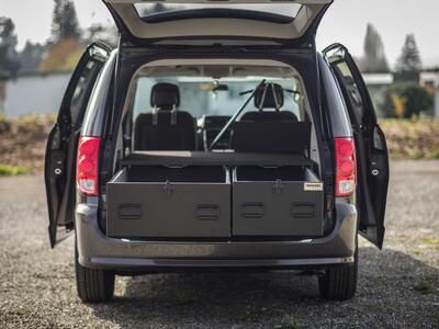 The back of a black Dodge Caravan with a magnum height TruckVault 