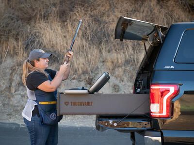 Olympian Kim Rhode loading her shotgun out of the back of a TruckVault.