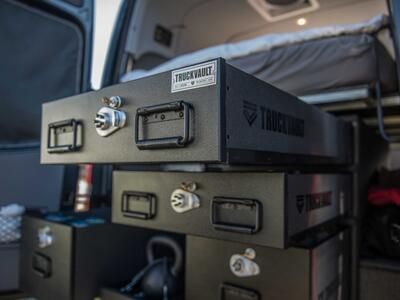 A TruckVault secure storage system in the back of a Mercedes Sprinter van.