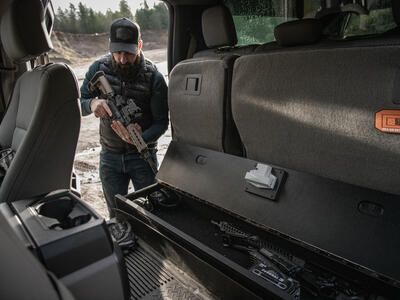 A man checking his rifle before he places it into a SeatVault.