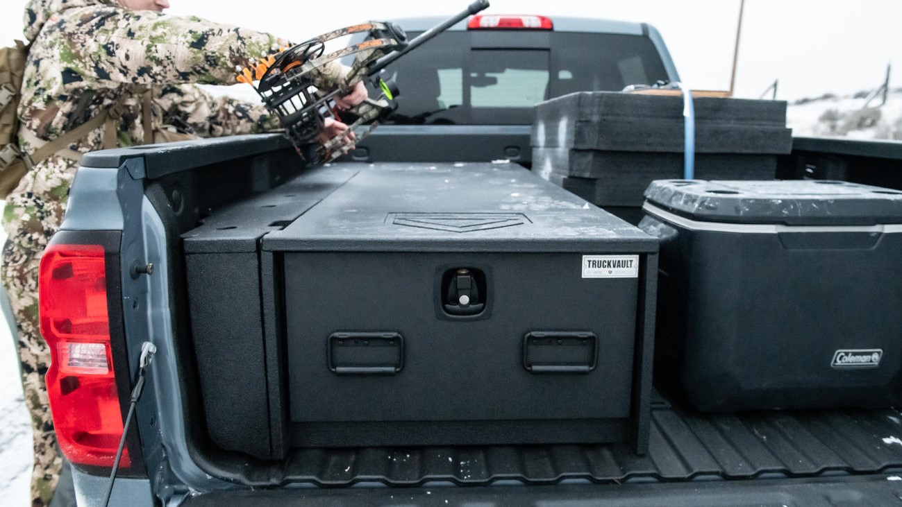 A Chevy Silverado with a half-width All-Weather TruckVault secure storage system in the bed.