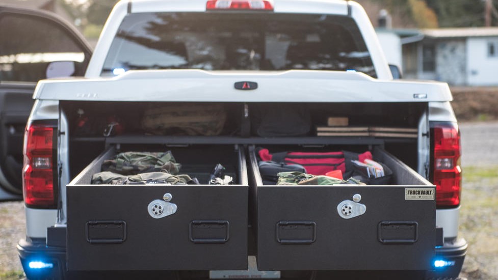 A Chevy Silverado with a Covered Bed TruckVault secure storage system installed in the bed.