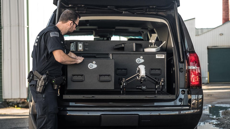 A Drone Series TruckVault secure storage system in the back of a Chevy Suburban.