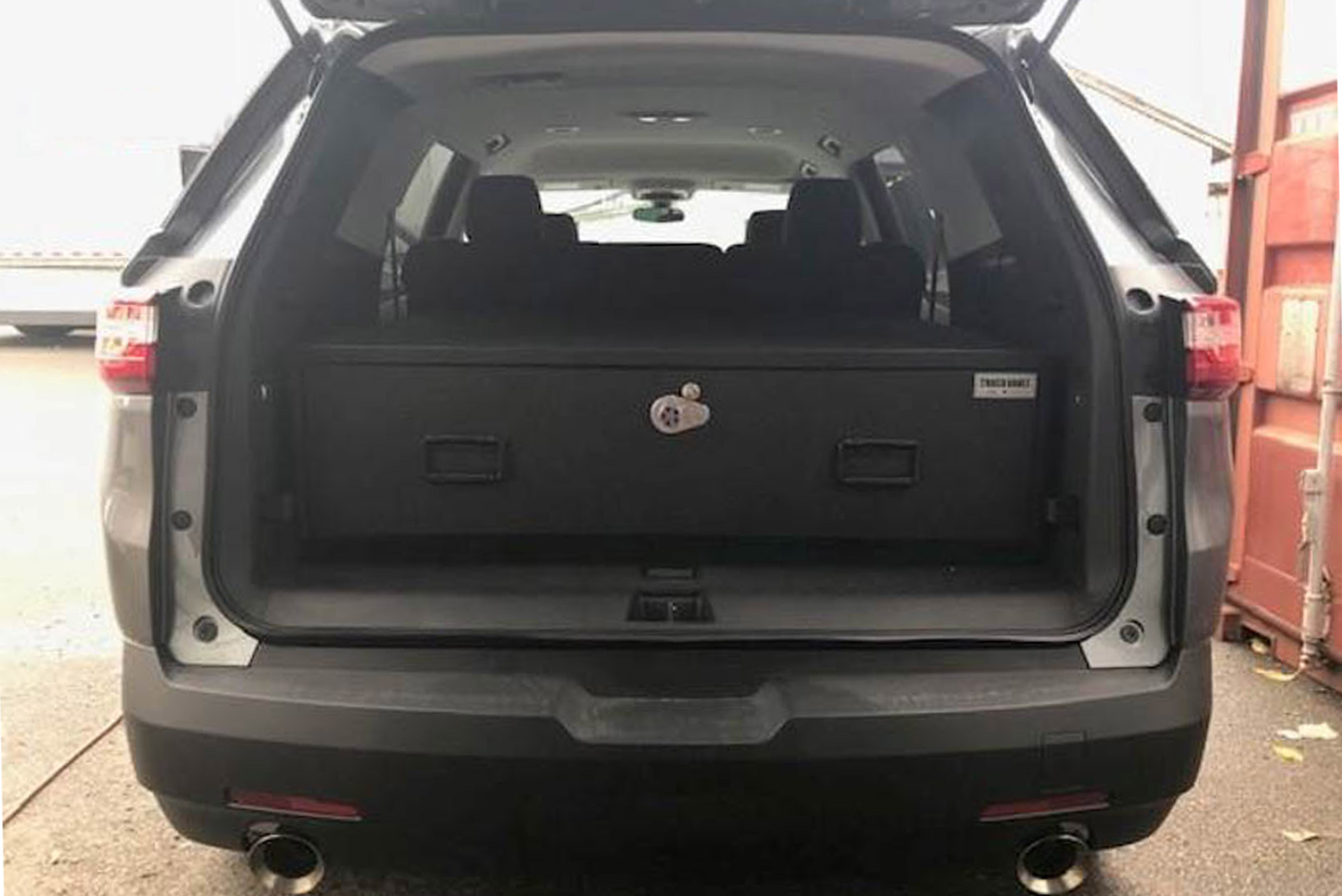 A gray Chevy Traverse with a TruckVault in the cargo space.
