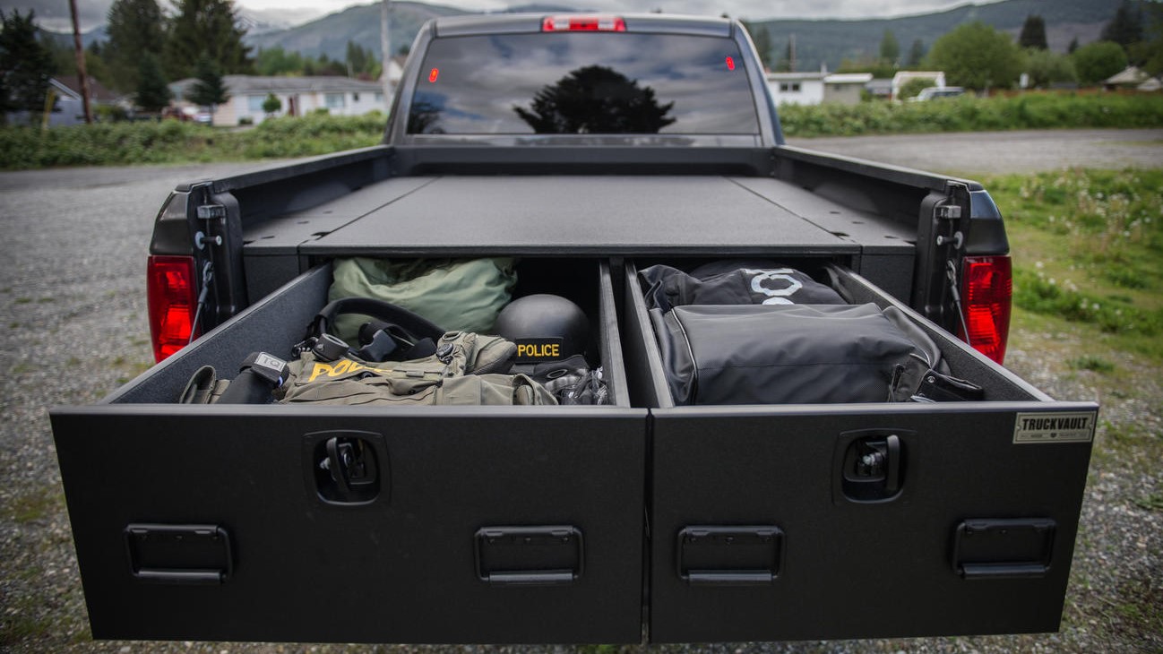 A Dodge Ram with a TruckVault All-Weather storage system with drawers pulled out.