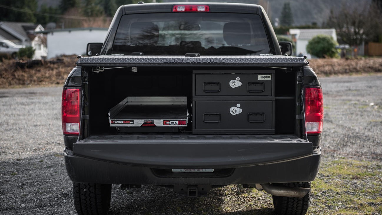 A Dodge Ram with a covered half-width TruckVault and a CargoGlide.