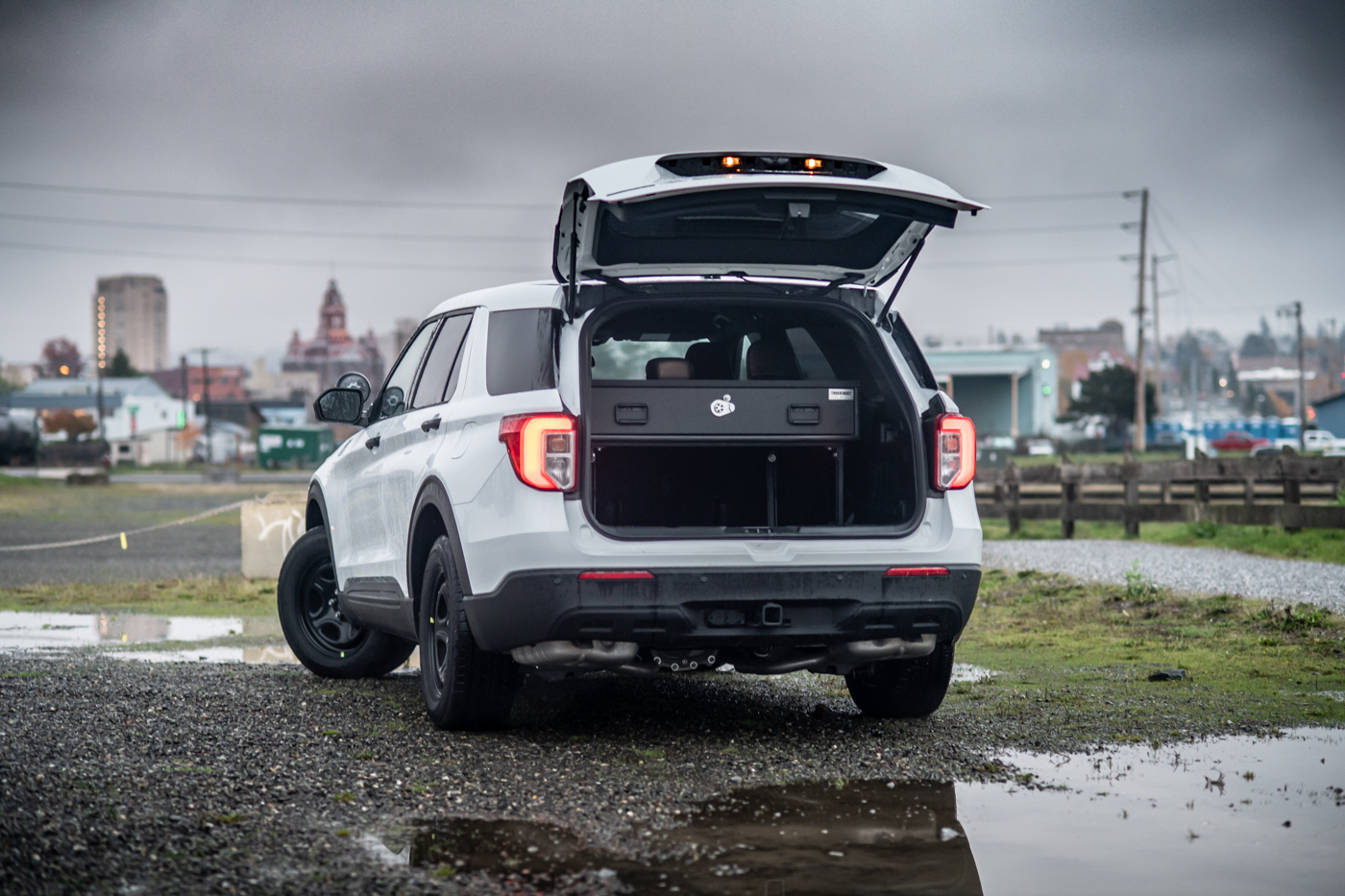 A white 2020 Ford Explorer with an Elevated TruckVault in the trunk.