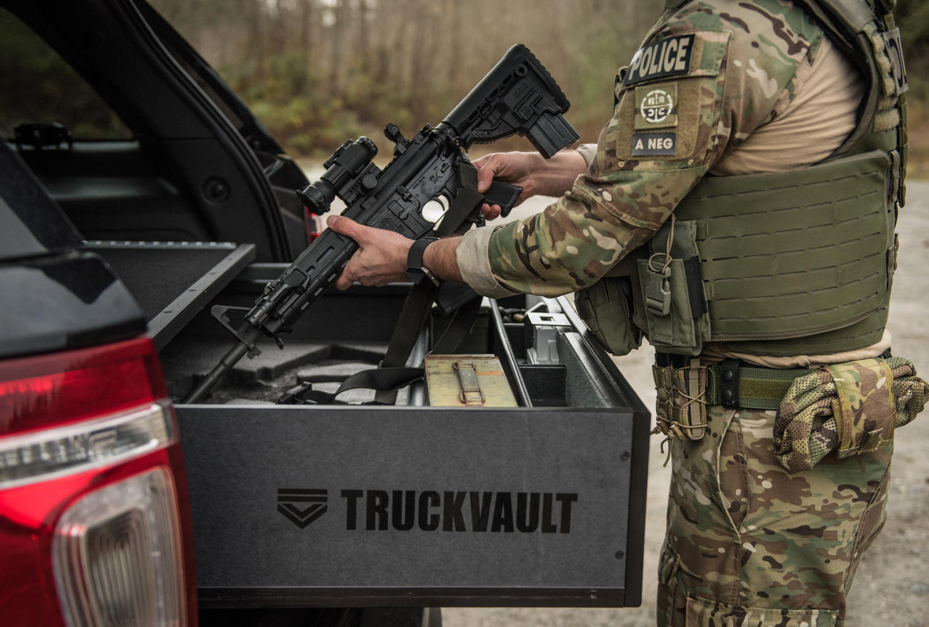 A police officer taking a gun out of his TruckVault.