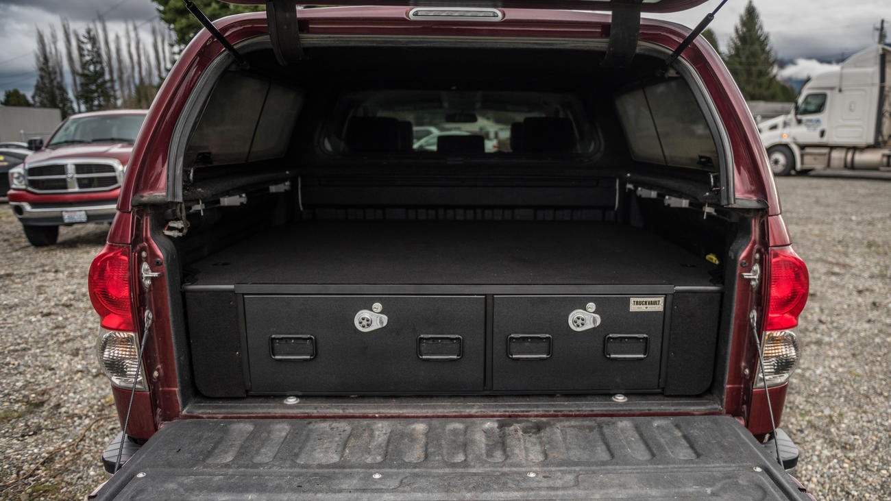 A Toyota Tundra with a Covered Bed Offset TruckVault storage system installed.