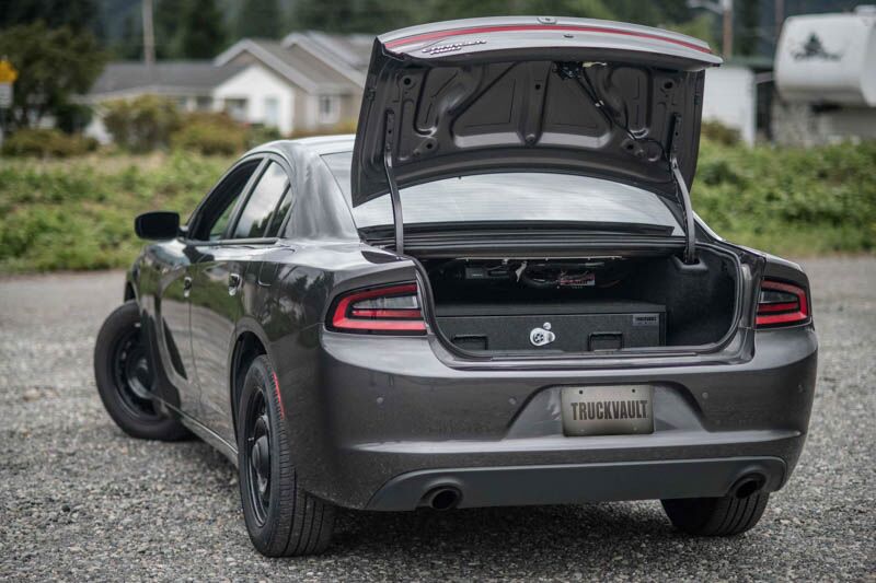 A gray Dodge Charger with a TruckVault in the trunk for secure storage.
