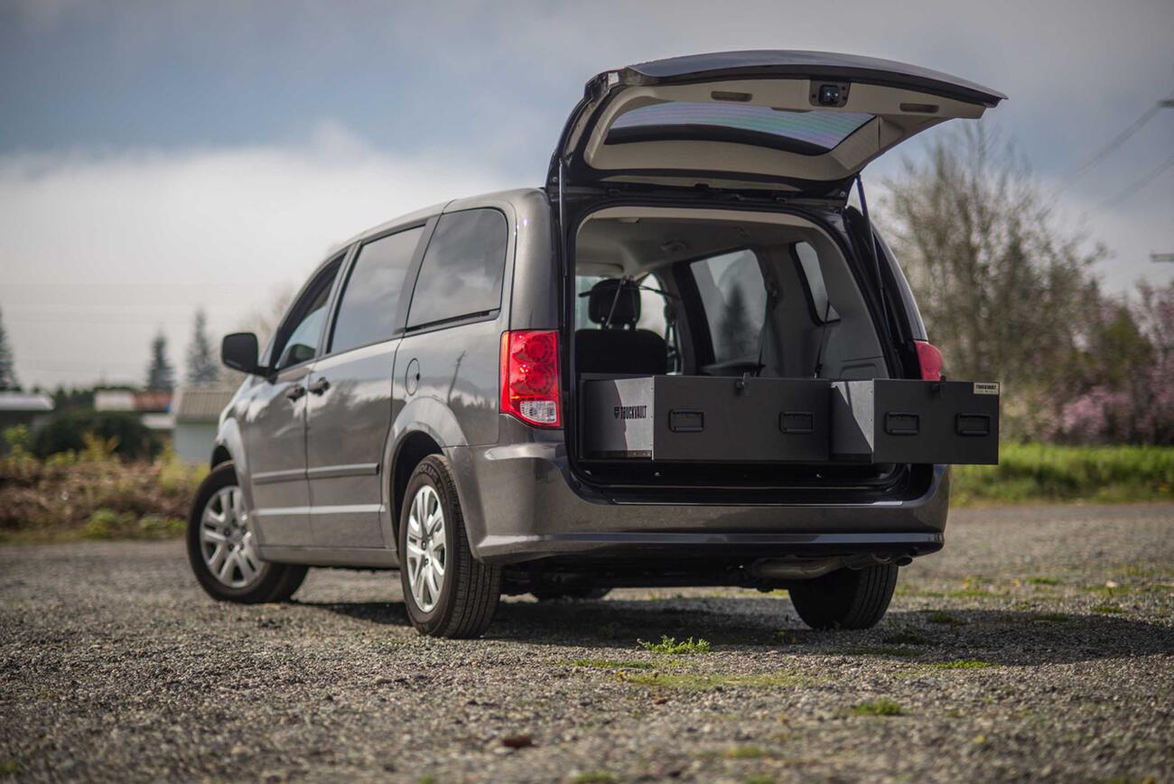 A black Grand Caravan with the trunk open and a magnum height TruckVault inside.