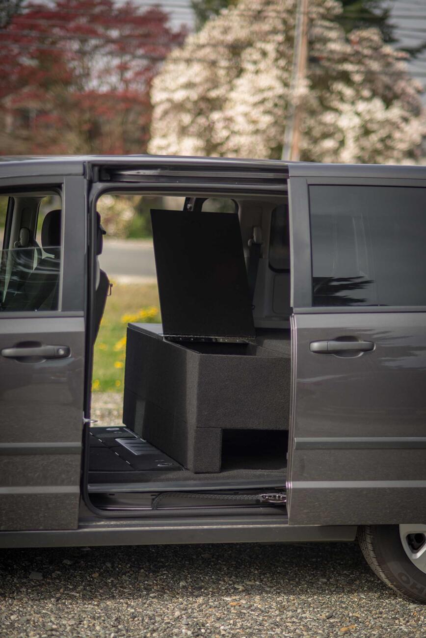 The side of a black Dodge Grand Caravan with a TruckVault inside.