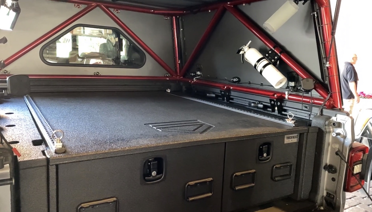 A Jeep Gladiator with a TruckVault storage system.