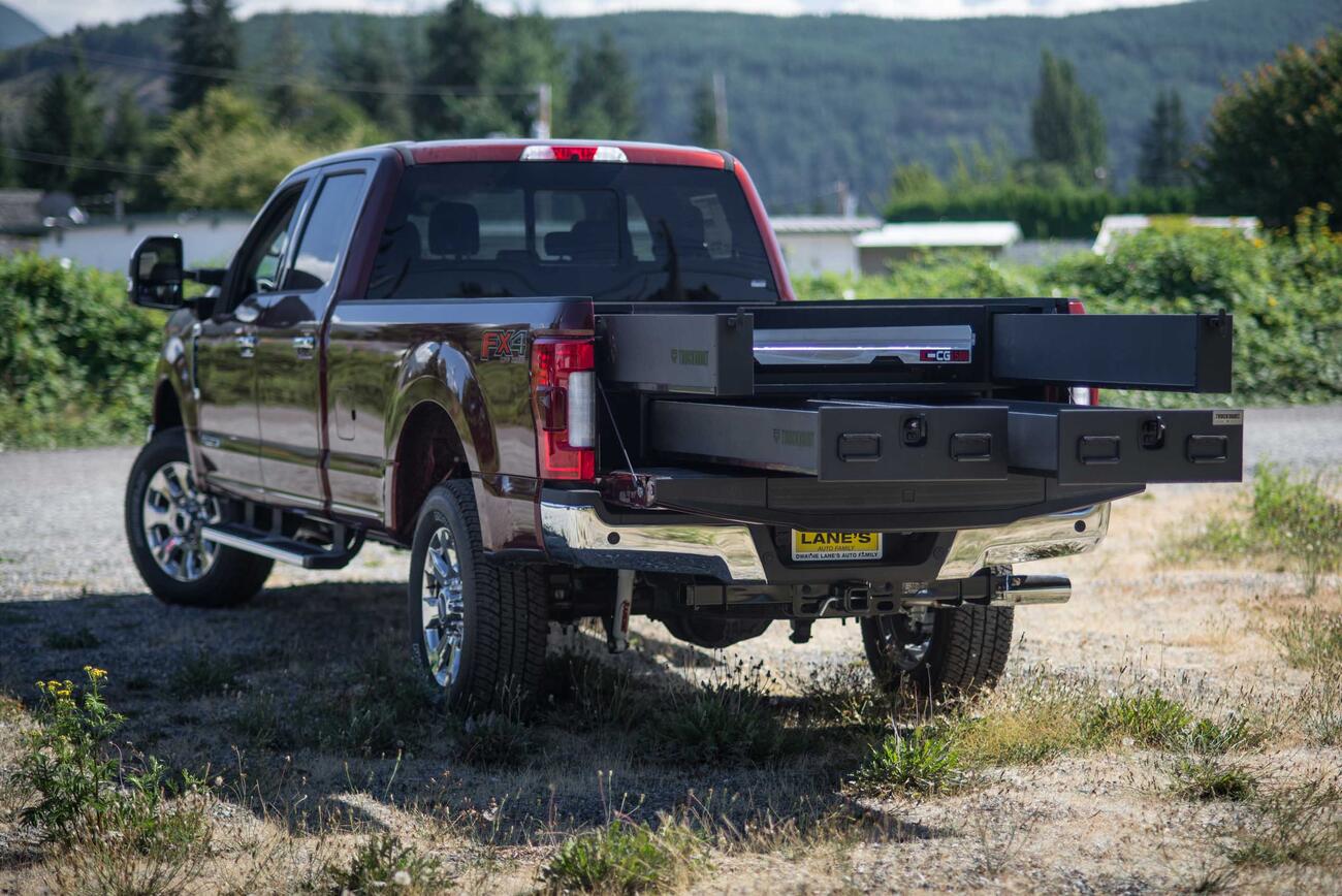 A Ford F250 with a custom 2 drawer TruckVault and a CargoGlide.