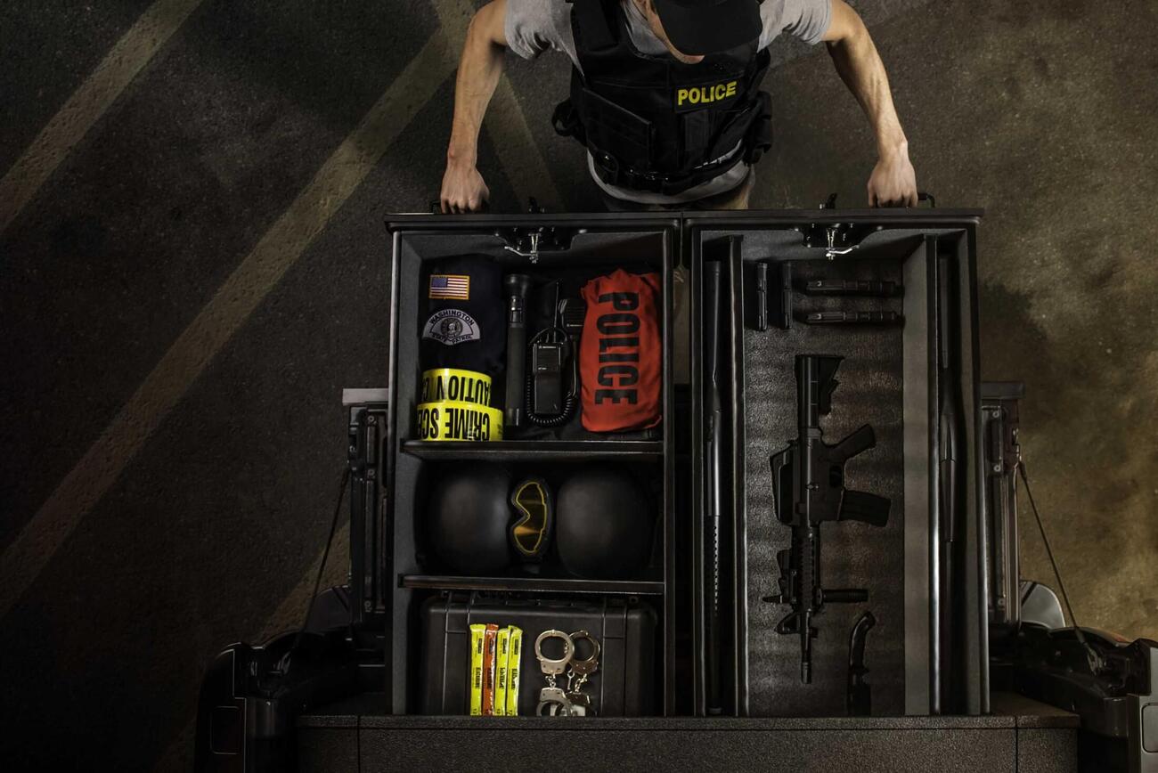 Police officer opening a TruckVault full of gear