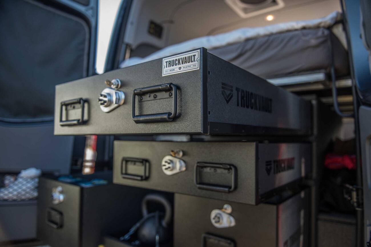 A TruckVault secure storage system in the back of a Mercedes Sprinter van.