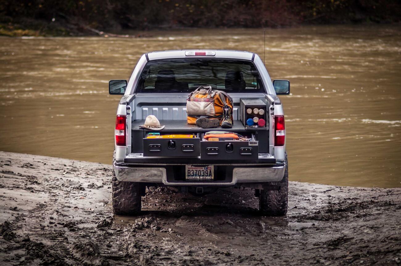 PickupSeries_All-WeatherLine_Standard2Drawer_2012_Ford_F150_Fishing1.jpg A Silver Ford F-150 All-Weather TruckVault filled with fishing gear.