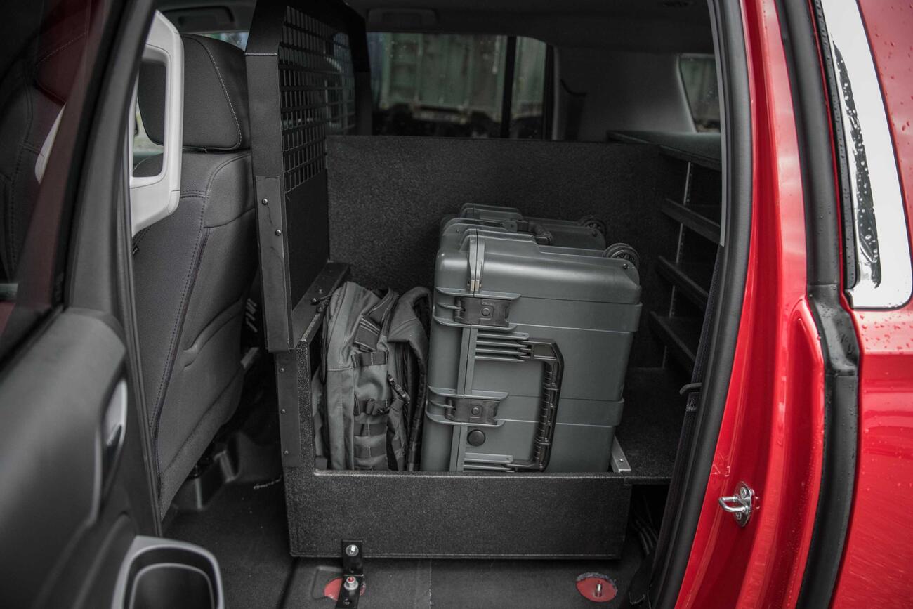 The Inside of a fire department Chevy Suburban with a custom TruckVault and Pelican case.