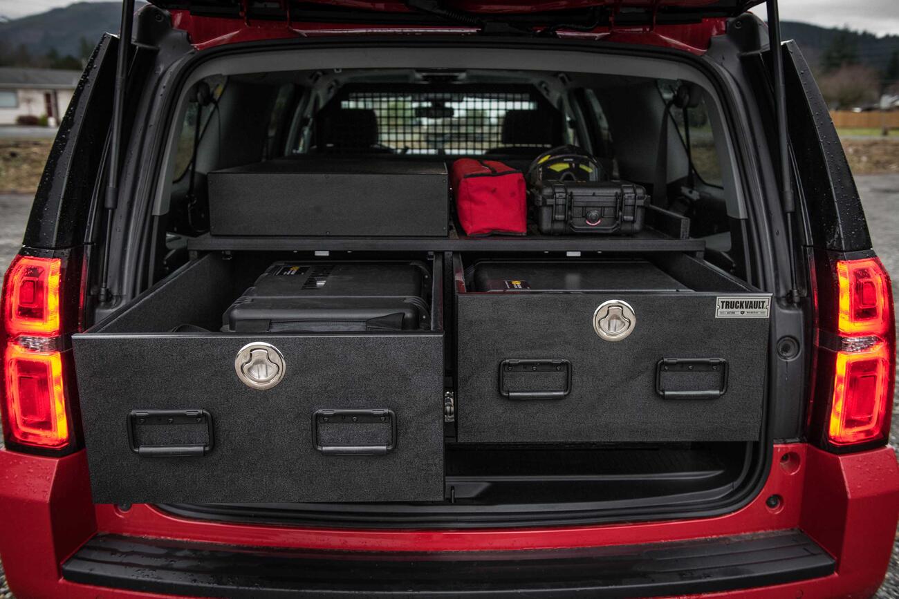 Fire/EMS Two open TruckVault drawers in the back of a red Chevy Suburban.