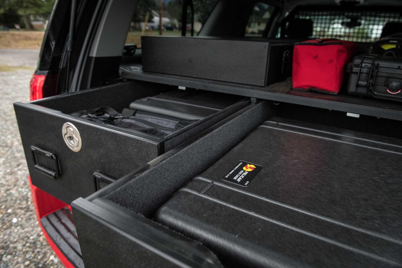 An up-close image of a custom, open TruckVault inside of a red Chevy Suburban.
