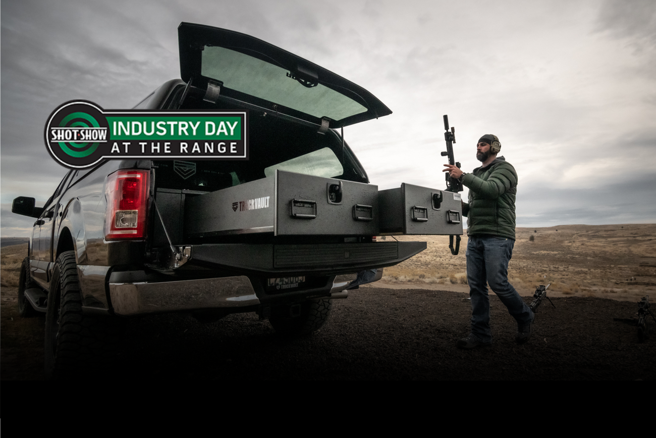 All-Weather 2-drawer system extends from a covered pickup truck. A tactical professional holds a rifle next to the drawers. The Industry Day at the Range logo appears on the left side.