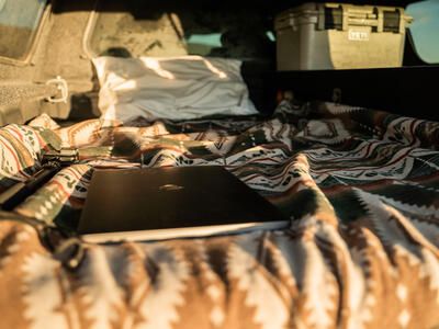 camping bed laptop and cooler in camping and overlanding TruckVault secure truck bed storage system