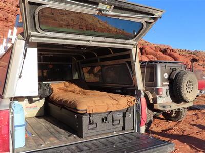 half width covered bed TruckVault secure storage system used as bed for overlanding truck camping