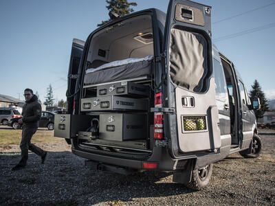 Overlanding camping vehicle organization using TruckVault secure storage system in Mercedes Sprinter van