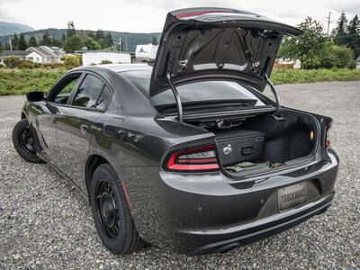 Sedan Baseline TruckVault secure vehicle storage inside Dodge Charger sedan with trunk open