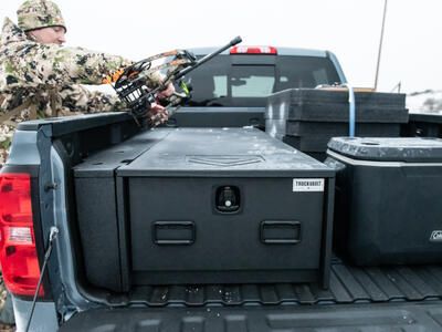 hunter assembling bow on top on TruckVault half width secure truckbed storage system