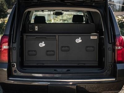 The back of Chevy Suburban with a TruckVault complete with a technology pack and pull-out table.