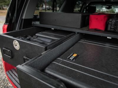 An up-close image of a custom, open TruckVault inside of a red Chevy Suburban.